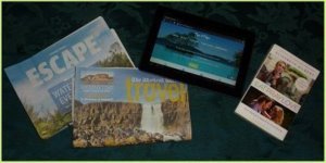 The travel section of the newspaper, ipad with travel blog, travel novel Eat Pray Love all inspiration on how to find a travel destination