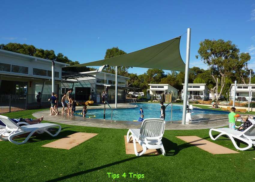swimming pool surrounded by deck chairs at the Cervantes Holiday Park