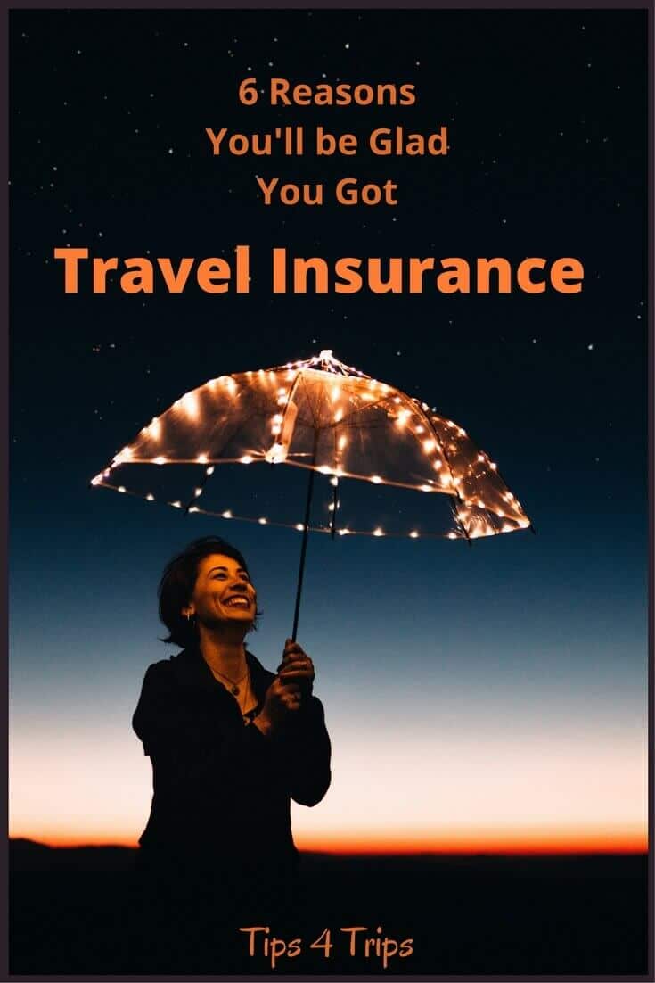 lady under umbrella at night happy she has travel insurance