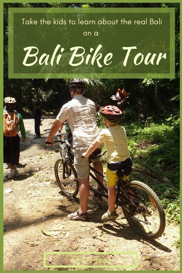 Father and son on a tandem bike during a Bali bike tour from Ubud