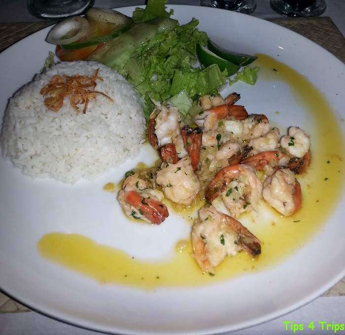 Plate of buttered garlic prawns and steamed rice from Bennos beachside restaurant