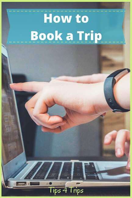 Pointing at screen on computer to find travel booking tips