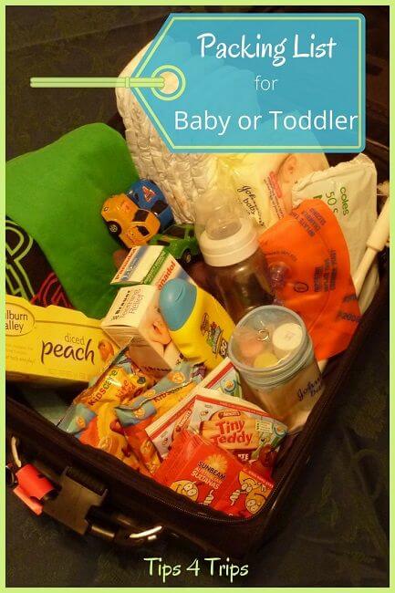 A bag filled with must have items for traveling with baby like snacks, nappies and toys