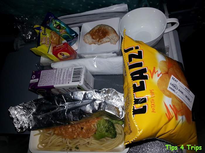 Singapore Airlines child meal in economy consisting of crisps, juice, crackers dried fruit, freddo and bolognaise