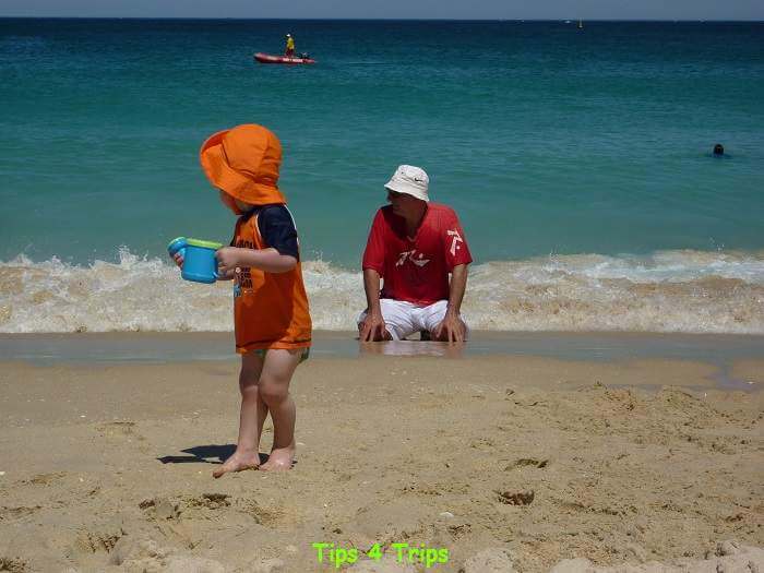 Toddler at the beach with bucket