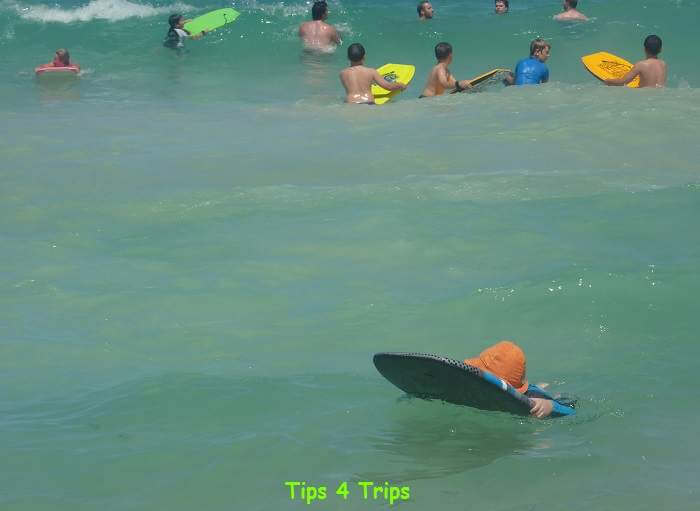 Kids boogie boarding in the beach waves