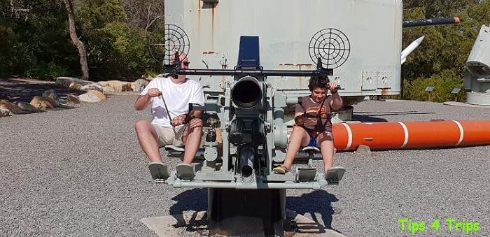 Playing on large old military guns near Anzac Museum