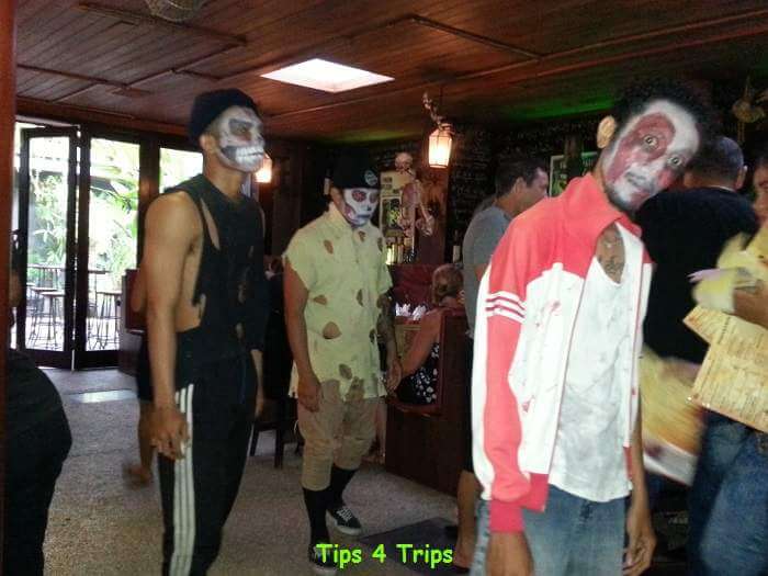 Dancers entering Frankenstein's laboratory restaurant with scary masks