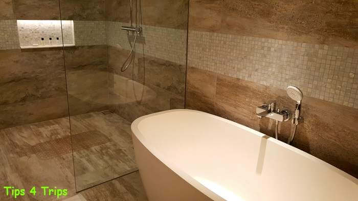 New Deluxe Chalet Padma bathroom with large soaking tub and extra large standing shower with beige tiles