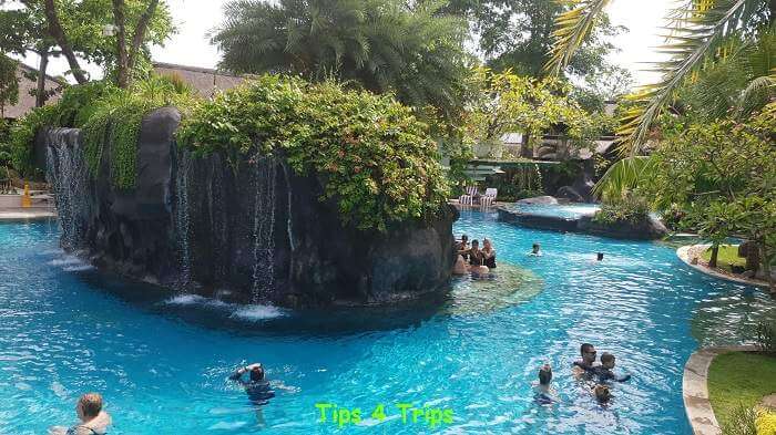 An island in the middle of the lagoon pool with water cascading down