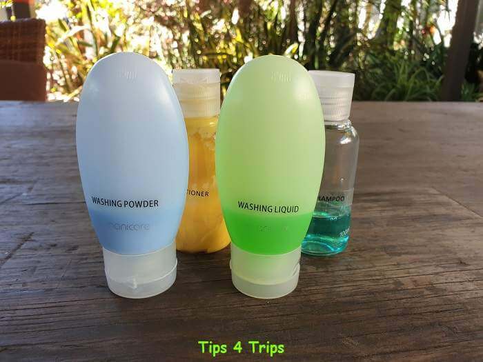 Trvel bottles filled with shampoo, conditioner, washing powder and washing liquid