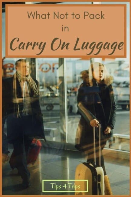 blurred people at airport with carry on essentials