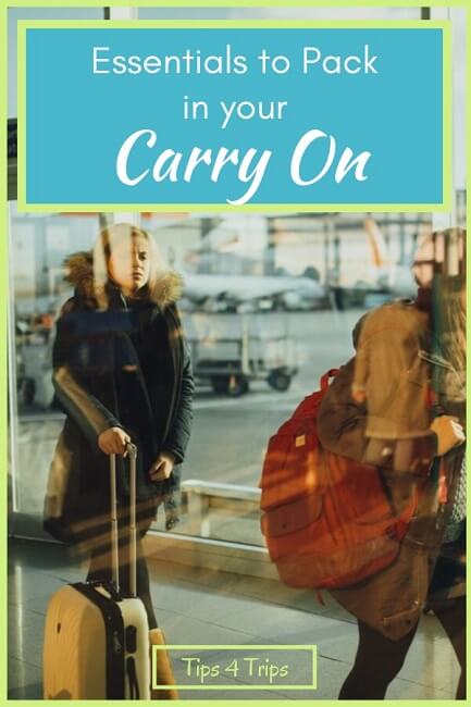 blurred people walking through airport with carry on bags