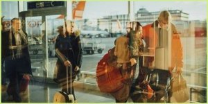 blurred people at airport with essential hand luggage items
