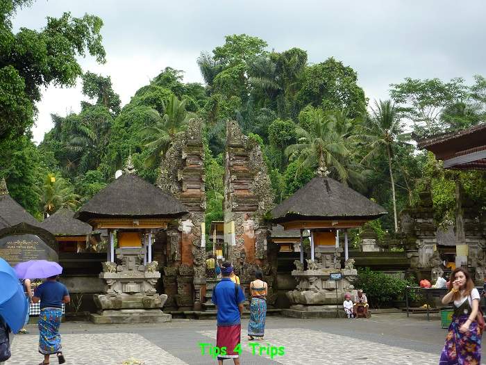 people walking into a Bali temple wearing sarongs