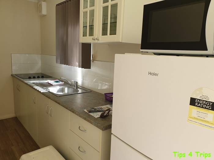 A Riverview Tourst Park review of the the kitchen with fridge and microwave