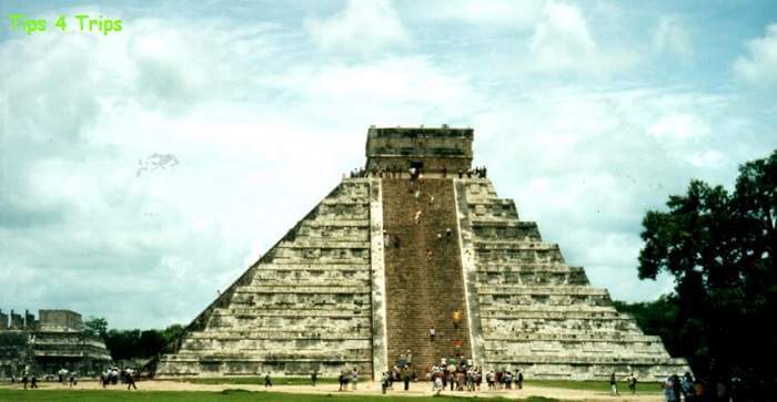 People climbing the stairs of the temple in Chitchen Itza Mexico