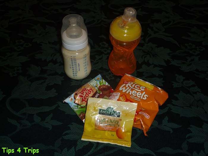 milk, water bottle, snack packs of biscuits and dried fruit