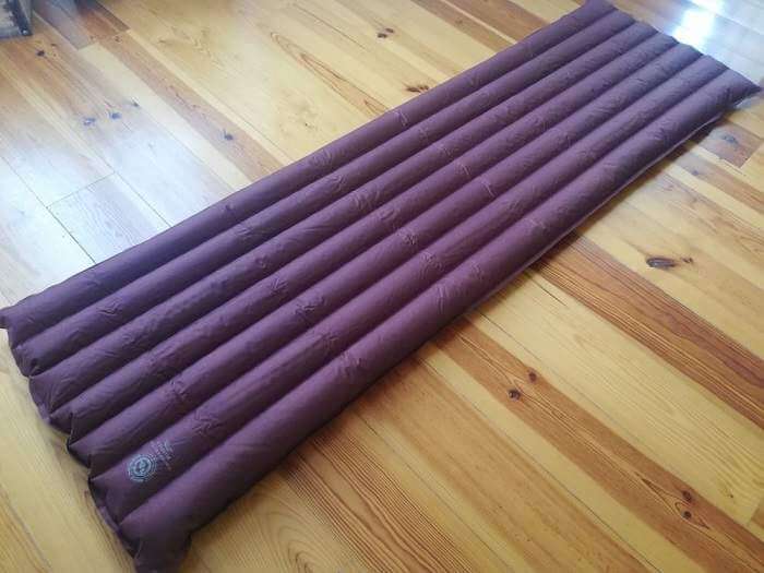purple inflatable mattress on floor