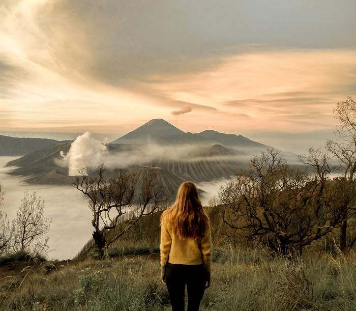 woman looking at foggy mountains
