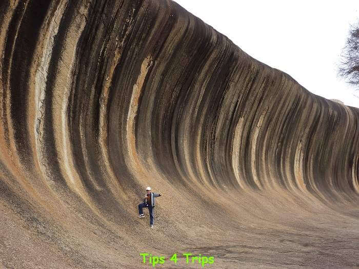 boy standing at base of Wave Rock, Western Australia