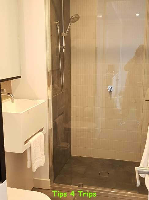 white vanity basin and soft grey shower