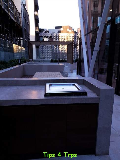 stainless steel BBQ and timber table