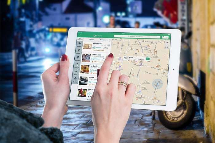 woman pointing to map on ipad