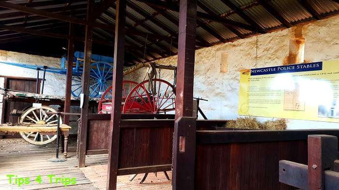 old horse carts inside wooden stables
