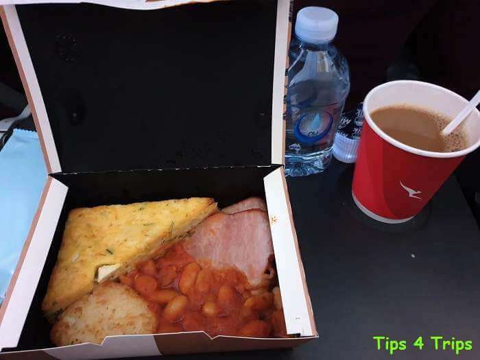 breakfast meal of frittata, bacon, beans and hash brown served on Qantas in economy