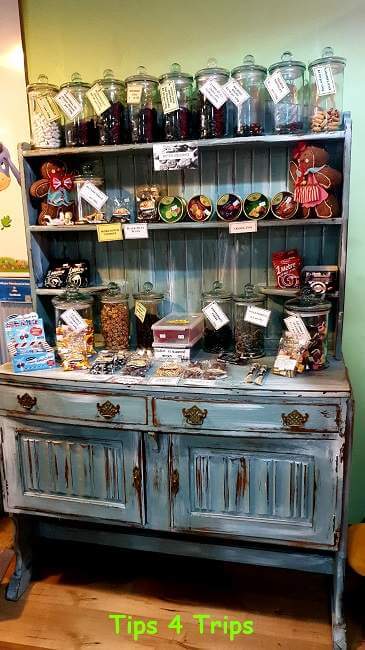 old cabinet with glass jars of lollies