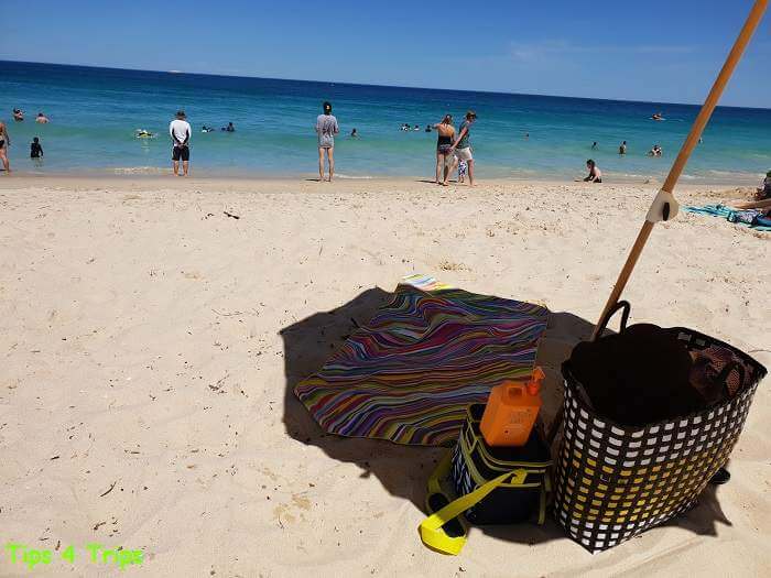 towel and beach bag on the sand at the beach