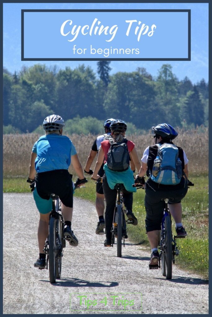 group of people riding bikes on a dirt road with helmets on and wearing back packs