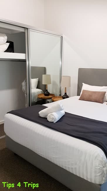 Queen bed and mirrored wardrobe in RAC Karri Valley Resort chalet