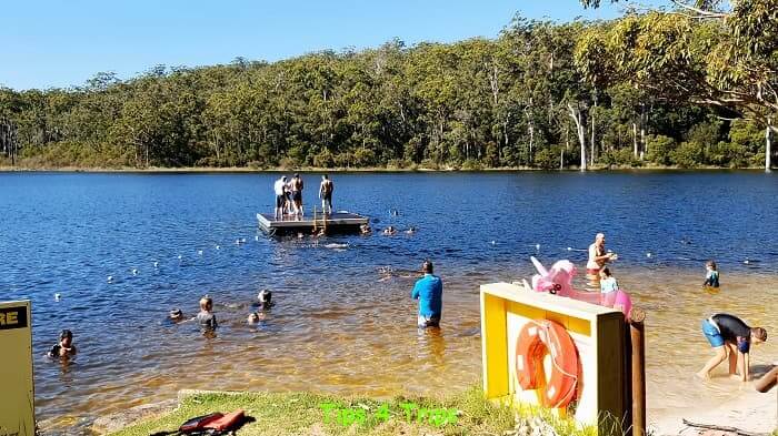 People swimming and on pontoon at Lake Beedalup