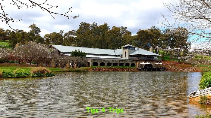 looking across pond to stone wine building