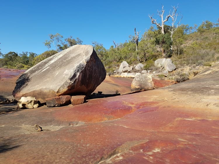 large sheer rock on large red coloured granite rock at Berry Reserve a Perth day trip