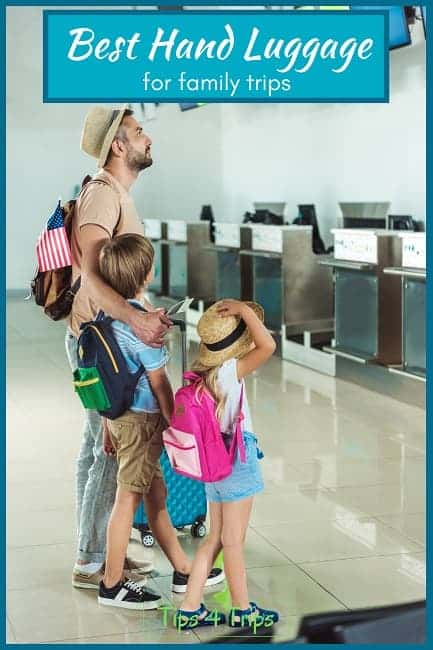 father with son and daughter at airport checking counters all with backpack for travel